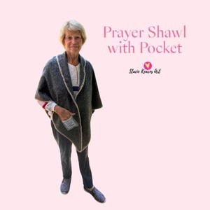 May include: A gray prayer shawl with a pocket, trimmed with cream-colored stitching. The shawl is draped over a person. The text "Prayer Shawl with Pocket" is displayed in pink, along with the artist's name.