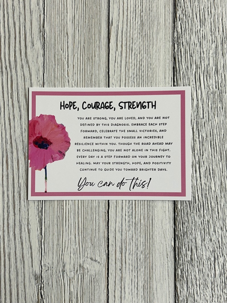 May include: A pink and white inspirational quote card with a pink poppy flower graphic. The text reads "Hope, Courage, Strength. You are strong, you are loved, and you are not defined by this diagnosis. Embrace each step forward, celebrate the small victories, and remember that you possess an incredible resilience within you. Though the road ahead may be challenging, you are not alone in this fight. Every day is a step forward on your journey to healing. May your strength, hope, and positivity continue to guide you toward brighter days. You can do this!"