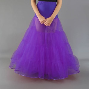 Peut inclure: Une jupon en tulle violet à plusieurs couches. Le jupon est ample et fluide, et il serait parfait pour ajouter du volume à une jupe ou une robe.