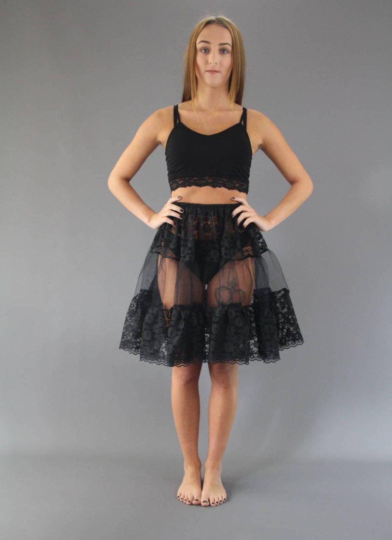 Black lace and net petticoat. Tiered design with lace at both the top and bottom and net in between. Edged in a delicate lace. Elasticated waist made to order.