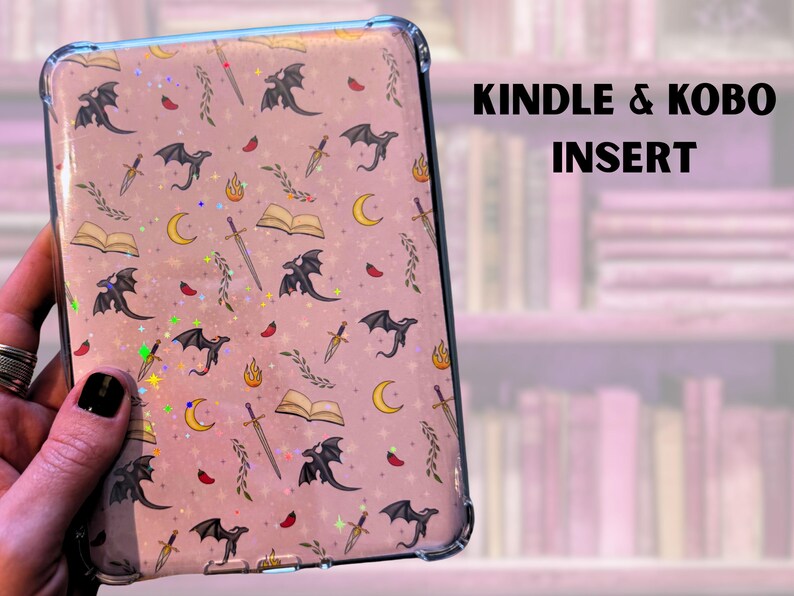 May include: A clear plastic case with a pink background and a repeating pattern of black dragons, swords, open books, and crescent moons. The text "KINDLE & KOBO INSERT" is printed in black at the top of the image.