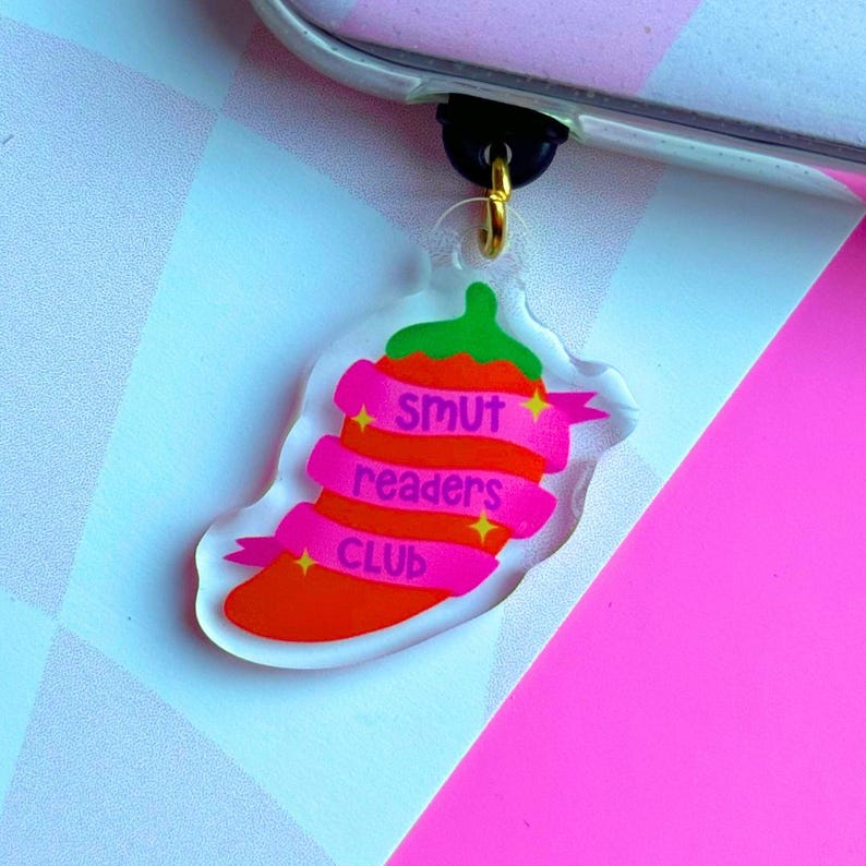 May include: A red chili pepper charm with pink ribbons that say "Smut Readers Club".