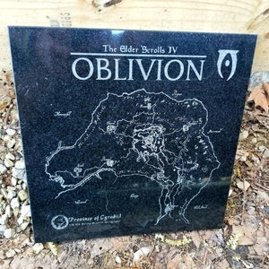 May include: A black granite plaque with the title "The Elder Scrolls IV: Oblivion" and a map of the province of Cyrodiil. The map is in white and shows the major cities and landmarks of the province.