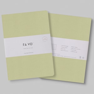 May include: A green notebook with a white label that says "FAVO" and "Limited Edition". The back of the notebook has information about the paper and materials used. The notebook is 100% recycled.