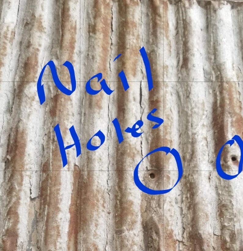 May include: Close-up of a rusty corrugated metal surface with blue painted text that reads "Nail Holes" and two blue circles with nail holes in the center.