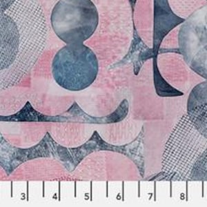 May include: A fabric print featuring a repeating pattern of dark blue watercolor-style circles and abstract shapes layered over a light pink background with a subtle grid texture. A white ruler at the bottom shows a scale of 12 inches.
