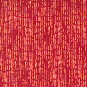 May include: Red fabric with a repeating pattern of thin, light orange and pink lines. The fabric has a subtle texture and a slightly faded look. The fabric is measured with a ruler that reads "moda" at the 2-inch and 6-inch marks.