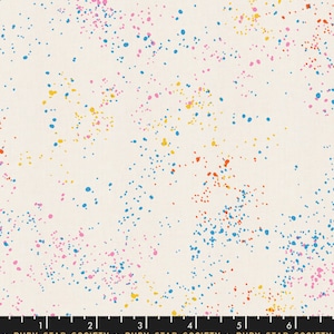 May include: Off-white fabric with a colorful splatter pattern. The design features small, irregular dots in shades of blue, pink, yellow, and red scattered across the surface. The bottom of the image has a ruler and the text "RUBY STAR SOCIETY".