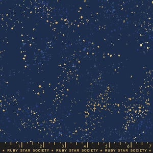 May include: Dark blue fabric with a speckled pattern of gold and blue dots. The fabric has a celestial or starry night appearance. The text at the bottom reads "RUBY STAR SOCIETY".