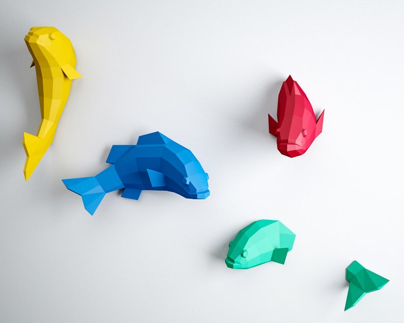 May include: Five origami fish wall decorations in various colors. A yellow fish, a blue fish, a red fish, a green fish, and a smaller green fish.
