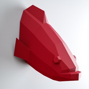 May include: A red origami fish wall sculpture. The fish is made of folded paper and has a geometric design.