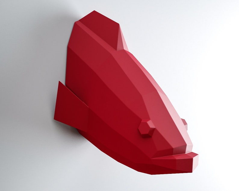 May include: A red origami fish wall sculpture. The fish is made of folded paper and has a geometric design.