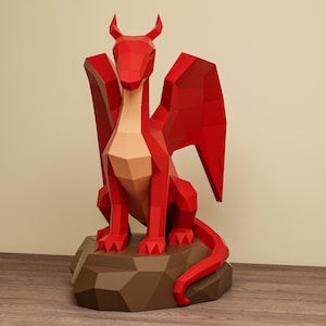 May include: A red geometric dragon sculpture with wings, horns, and a long tail, perched on a brown, rocky base. The dragon has a light tan chest and is set against a neutral background. The sculpture is made of angular, flat planes.