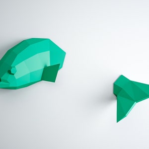 May include: A teal blue origami fish wall decor with a separate tail piece. The fish is made of paper and has a 3D effect.