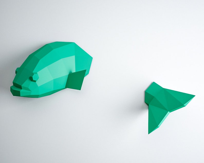 May include: A teal blue origami fish wall decor with a separate tail piece. The fish is made of paper and has a 3D effect.