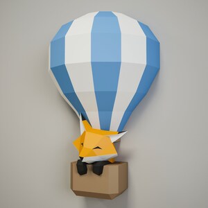 May include: A blue and white striped paper hot air balloon with a sleeping orange fox inside. The balloon is made of paper and has a brown paper basket.
