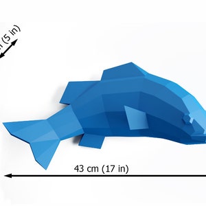 May include: A blue origami fish sculpture with a geometric design. The fish is 17 inches long, 9 inches tall, and 5 inches wide.