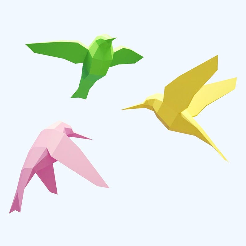May include: Three origami hummingbirds in flight, one green, one yellow, and one pink.