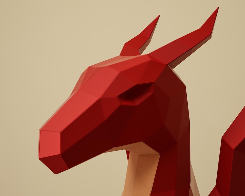 May include: A red, geometric dragon sculpture with a polygonal design. The dragon's head is angled to the left, with sharp, pointed ears and a detailed, angular face. The sculpture is a vibrant red colour.