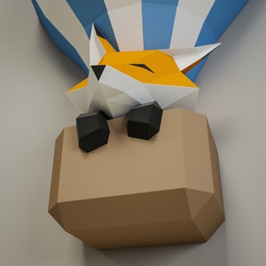 May include: A papercraft fox in a hot air balloon. The fox is orange and white with black eyes and nose. The balloon is blue and white with a brown paper basket.