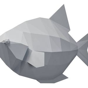 May include: A gray origami fish with a triangular fin and tail. The fish is made of paper and has a geometric design.