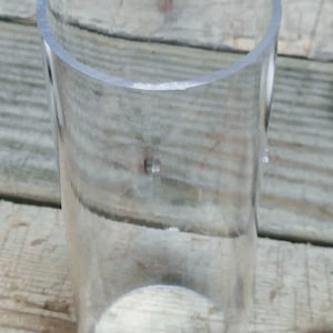 May include: A clear plastic tube, possibly for crafts or DIY projects.