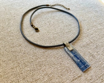 Kyanite on gray leather