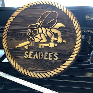 Seabee classic stencil logo burned deep into 1” thick solid wood.