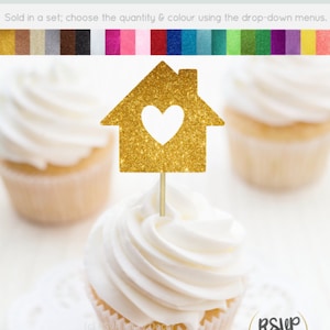 May include: Gold glitter cupcake topper shaped like a house with a heart cut out. The topper is on a cupcake with white frosting. The text "RSVP Party Decor" is visible in the bottom right corner of the image.