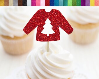 May include: A red glitter sweater-shaped cupcake topper with a white Christmas tree cutout, displayed atop a cupcake with white frosting. The image includes text: "Cupcake Toppers/Food Picks" and "RSVP PARTY DECOR".