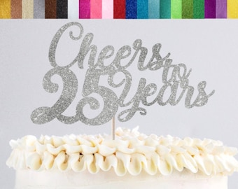 May include: Silver glitter cake topper with the text "Cheers to 25 Years".