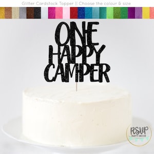 May include: Black glitter cardstock cake topper with the text "ONE HAPPY CAMPER".