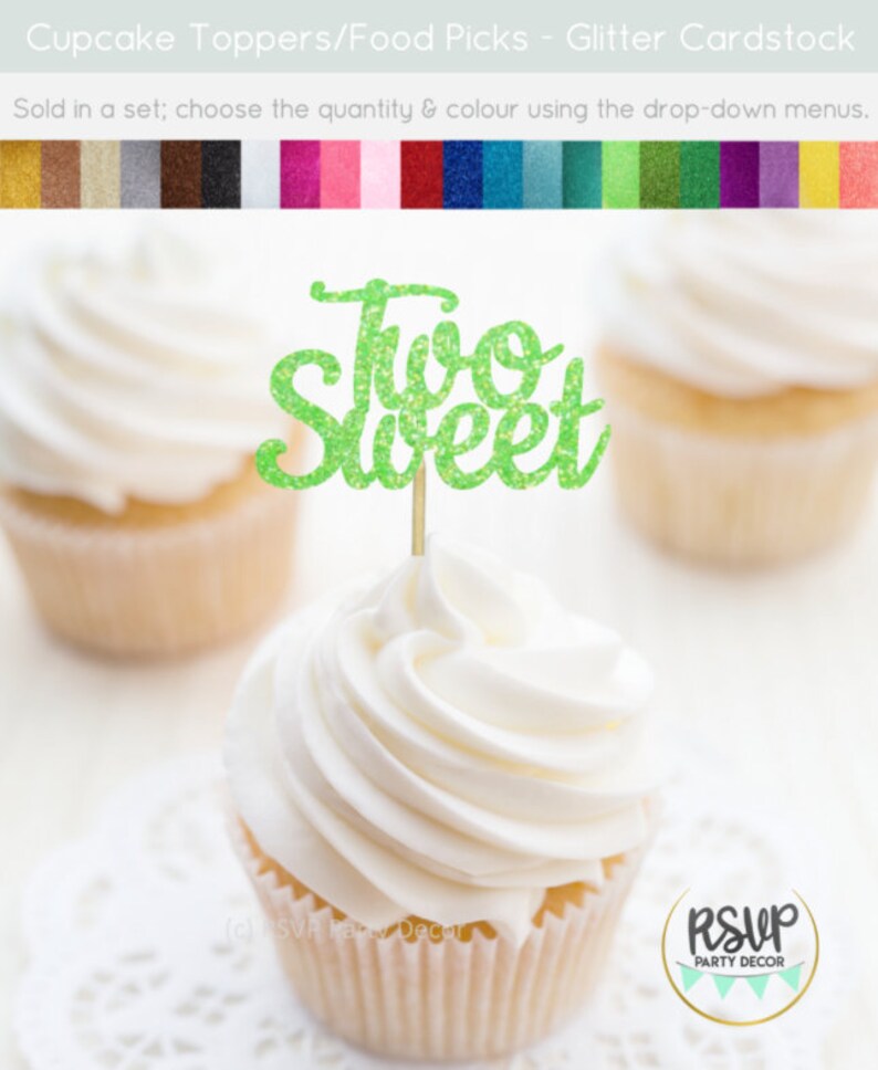 May include: Green glitter cupcake topper with the text "Two Sweet" on a white cupcake with white frosting.
