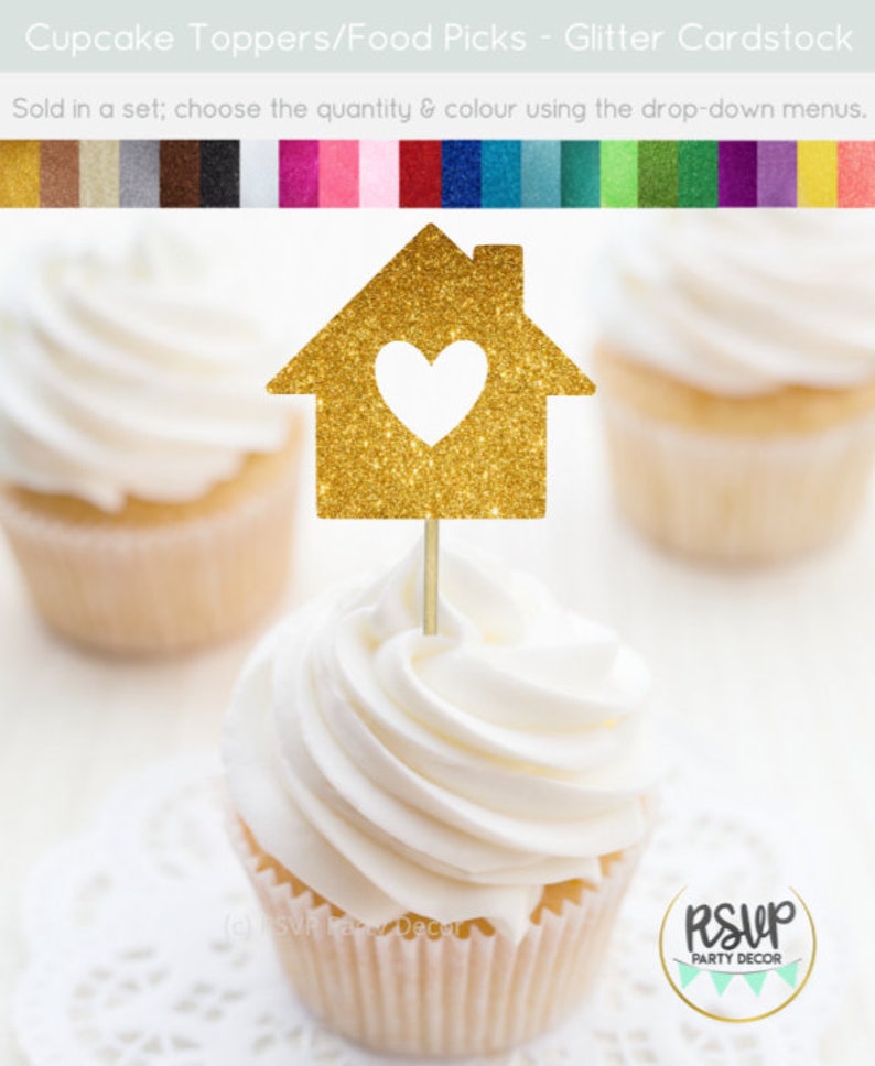 May include: Gold glitter cupcake topper shaped like a house with a heart cut out. The topper is on a cupcake with white frosting. The text "RSVP Party Decor" is visible in the bottom right corner of the image.