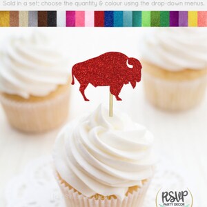 May include: Red glitter buffalo cupcake topper. The topper is on a white cupcake with white frosting. The cupcake is on a white doily. The background is white. "RSVP Party Decor" is printed on a gold circle.