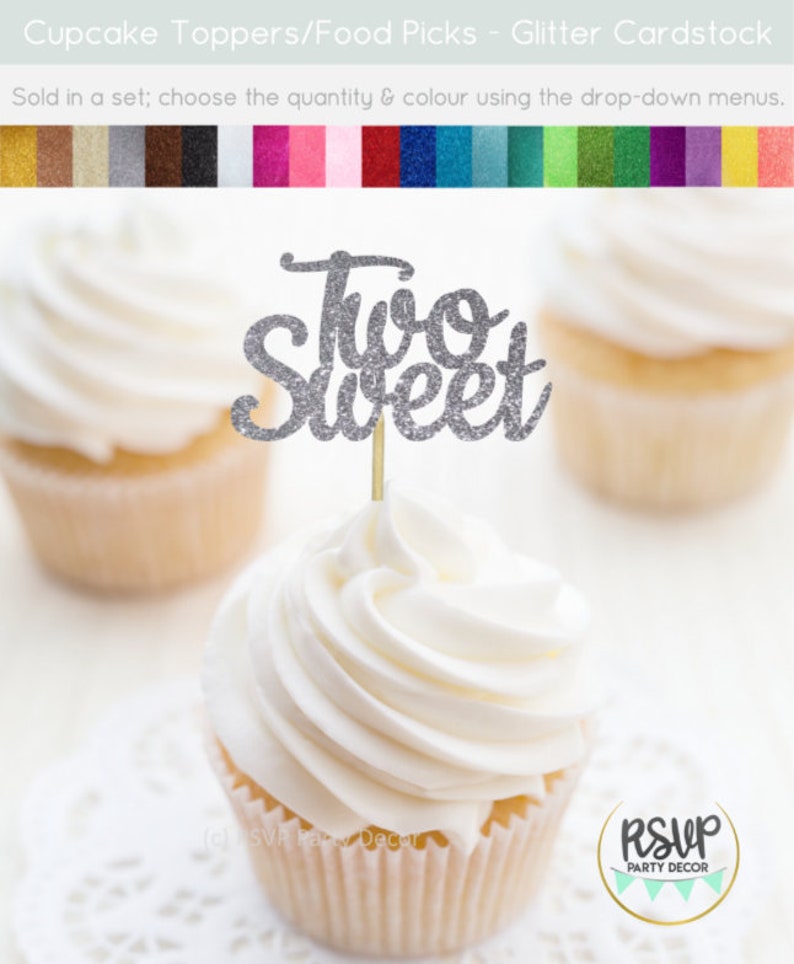 May include: Silver glitter cupcake topper with the words "Two Sweet" on a white cupcake.
