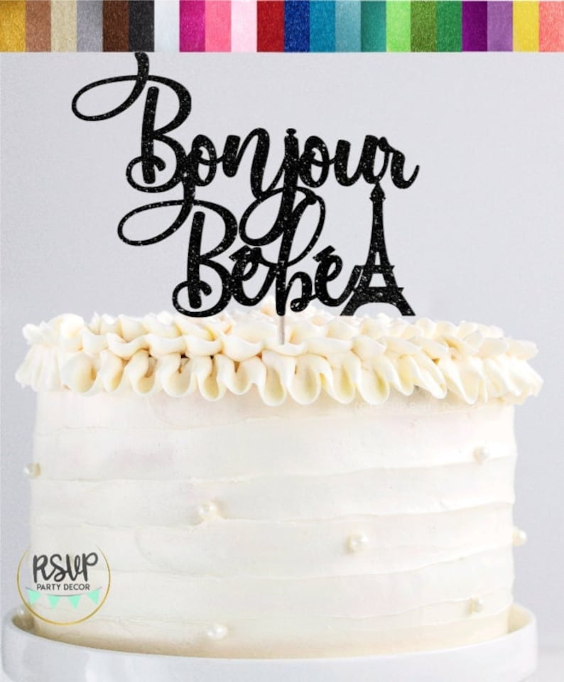 May include: Black glitter cake topper with the text "Bonjour Bebe" and a silhouette of the Eiffel Tower.