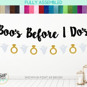 May include: A banner featuring the black glitter text Boo's Before I Do's suspended above a string of alternating white glitter ghost cutouts and gold glitter engagement ring cutouts. The banner is displayed against a plain white background.
