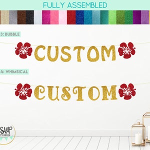May include: A gold glitter banner with the word "CUSTOM" in two different fonts. The banner is decorated with red glitter hibiscus flowers. The banner is fully assembled and ready to hang.