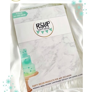 May include: A white and gray marble-patterned box with a gold logo that says "RSVP Party Decor". The box is labeled "Please - Do Not Bend" and has the text "Party Decor Products for Any Occasion" with a list of occasions: "Weddings | Bridal Showers | Anniversaries | Birthdays | Baby Showers | & More".