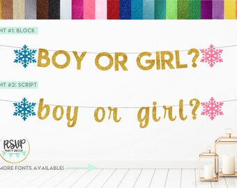 May include: Gold glitter "Boy or Girl?" banner with blue and pink snowflake accents. The banner is available in two fonts: block and script. The banner is for a gender reveal party.