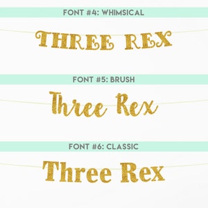 May include: Three different font styles for the text "Three Rex" are shown. The text is in gold glitter and is strung on a white string.