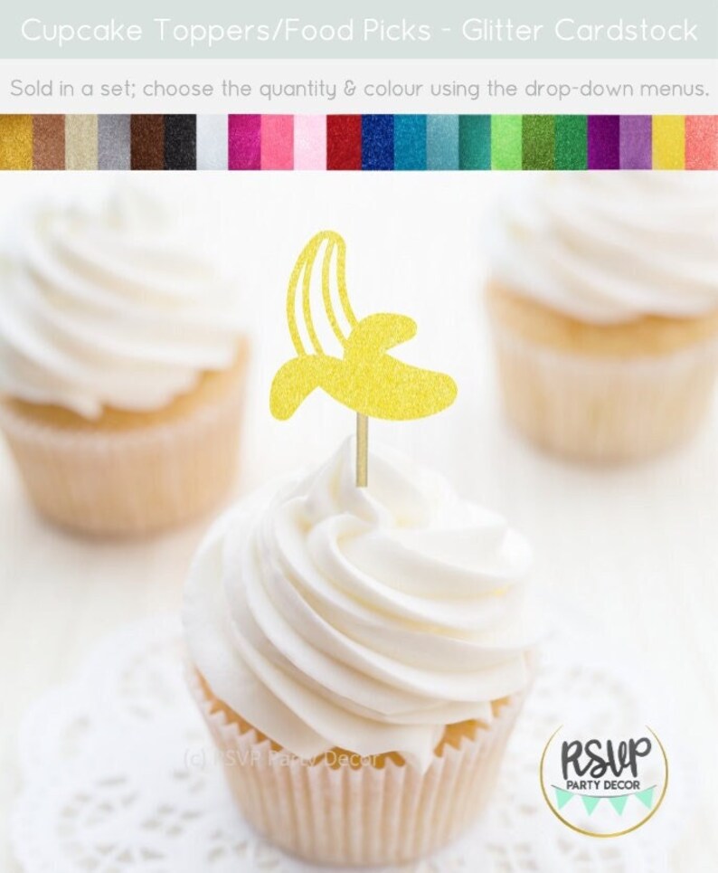 May include: Gold glitter cupcake topper shaped like a banana. The topper is on a white cupcake with white frosting. The text "RSVP Party Decor" is visible in the image.
