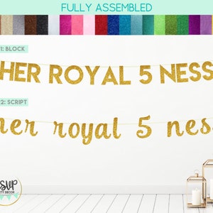 May include: Gold glitter banner with the text "HER ROYAL 5 NESS" in block letters and "her royal 5 ness" in script letters. The banner is strung on a white string and is hanging on a white wall.