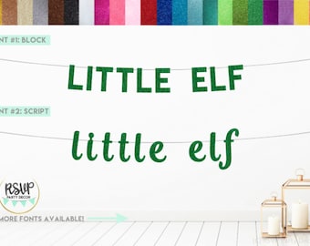 Puede incluir: Bandera de purpurina verde con las palabras "LITTLE ELF" en letras de bloque y "little elf" en escritura cursiva. La imagen también muestra una paleta de colores de papel de purpurina y linternas decorativas.