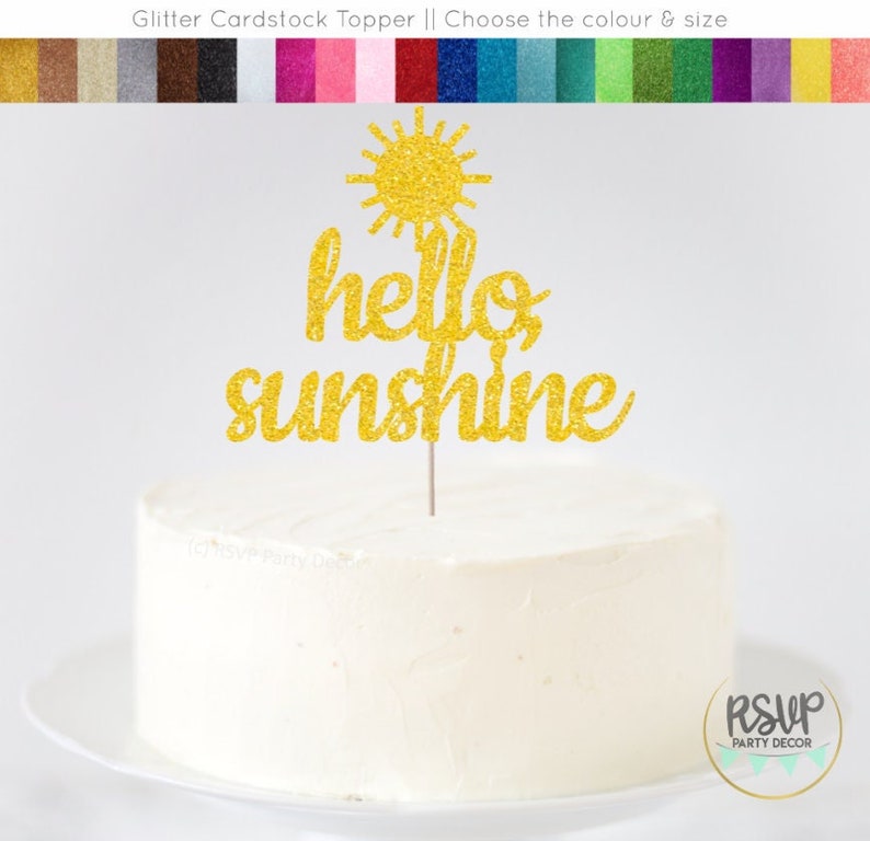 May include: Gold glitter cardstock cake topper with a sun and the words "hello sunshine".