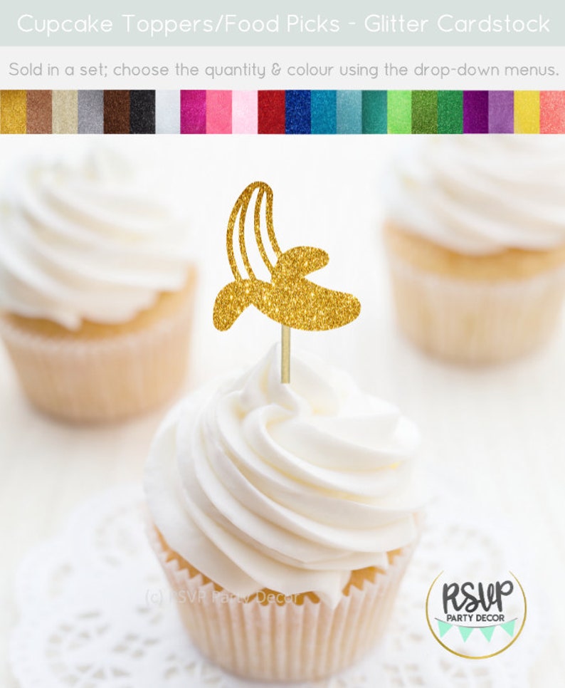 May include: Gold glitter cupcake topper shaped like a banana. The topper is on a white cupcake with white frosting. The cupcake is on a white doily. The text "RSVP Party Decor" is visible in the lower right corner of the image.