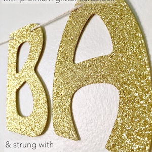 May include: Gold glitter cardstock banner with the letters "BA" strung with natural twine. The banner is made with premium glitter cardstock and is perfect for a party or event.