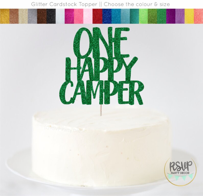 May include: Green glitter cardstock cake topper with the text "ONE HAPPY CAMPER".
