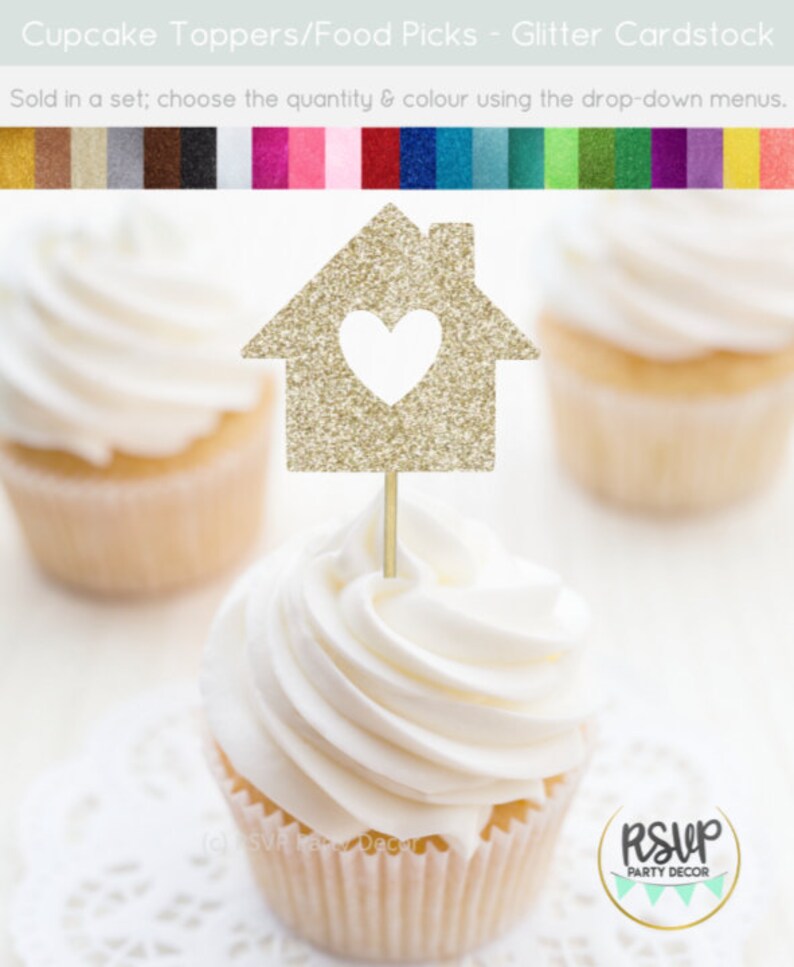 May include: Gold glitter cupcake topper shaped like a house with a heart cut out. The topper is on a white cupcake with white frosting. The text "RSVP Party Decor" is on a sticker on the cupcake.